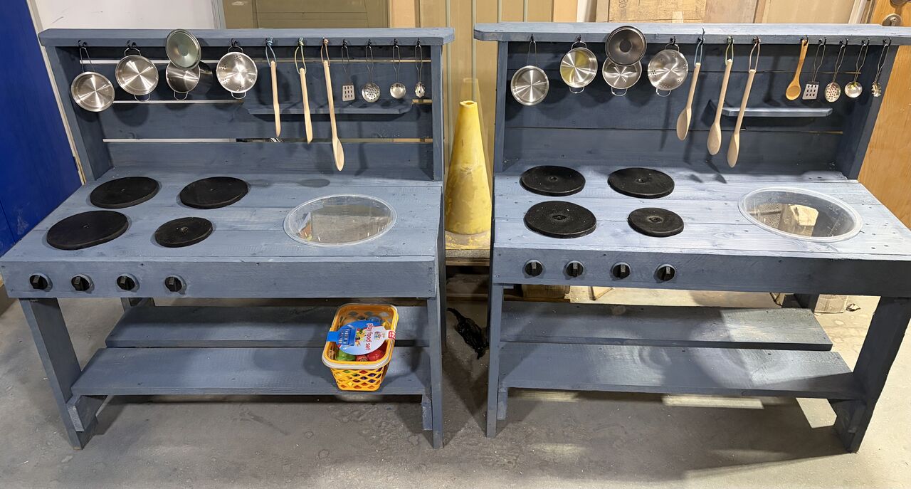 An employee of Fire Glass UK has created mud kitchens out of scrap wood for a local school